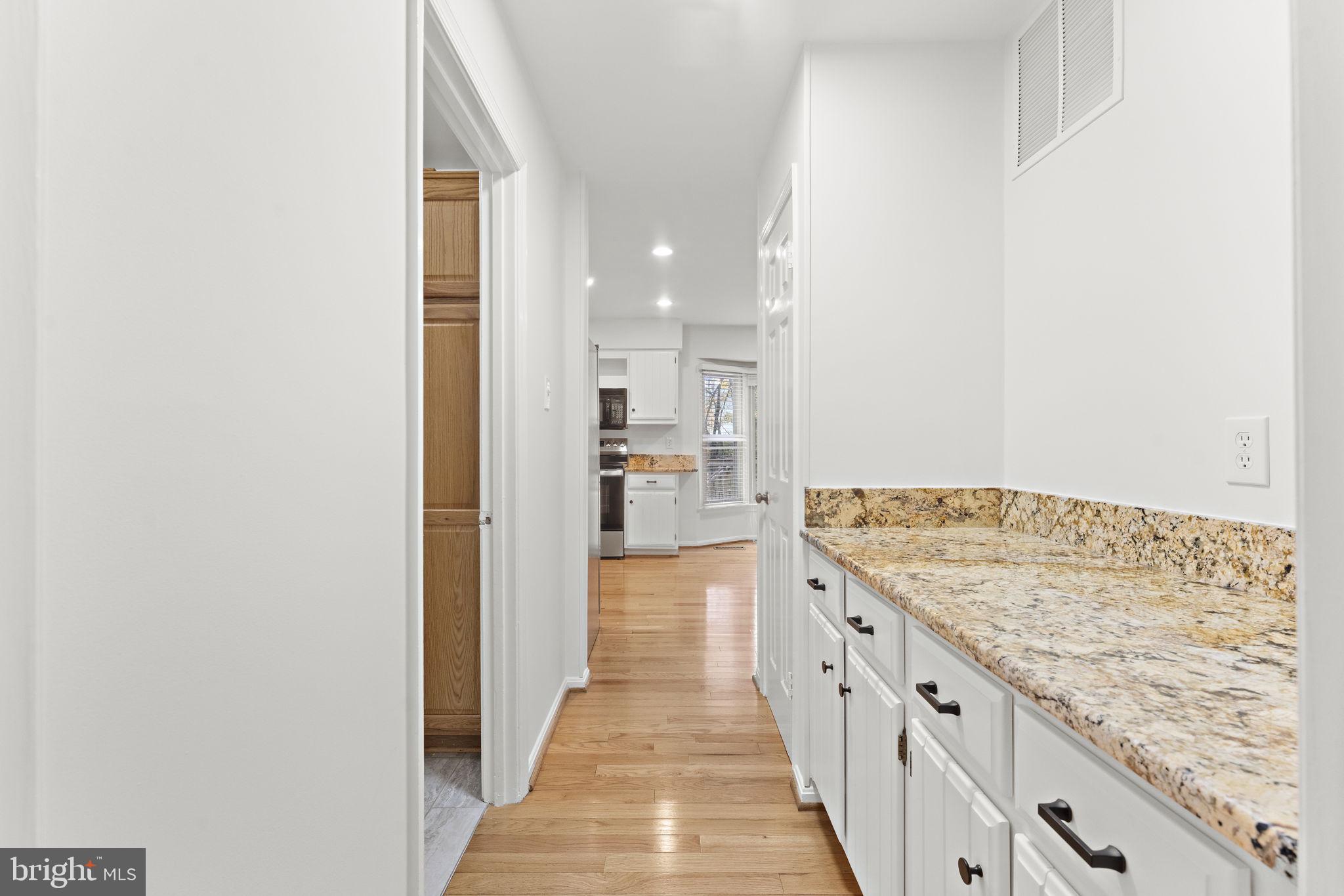 12574 Quincy Adams Court Herndon, VA 20171 - Photo 20 of 67 a view of a hallway with wooden floor and staircase