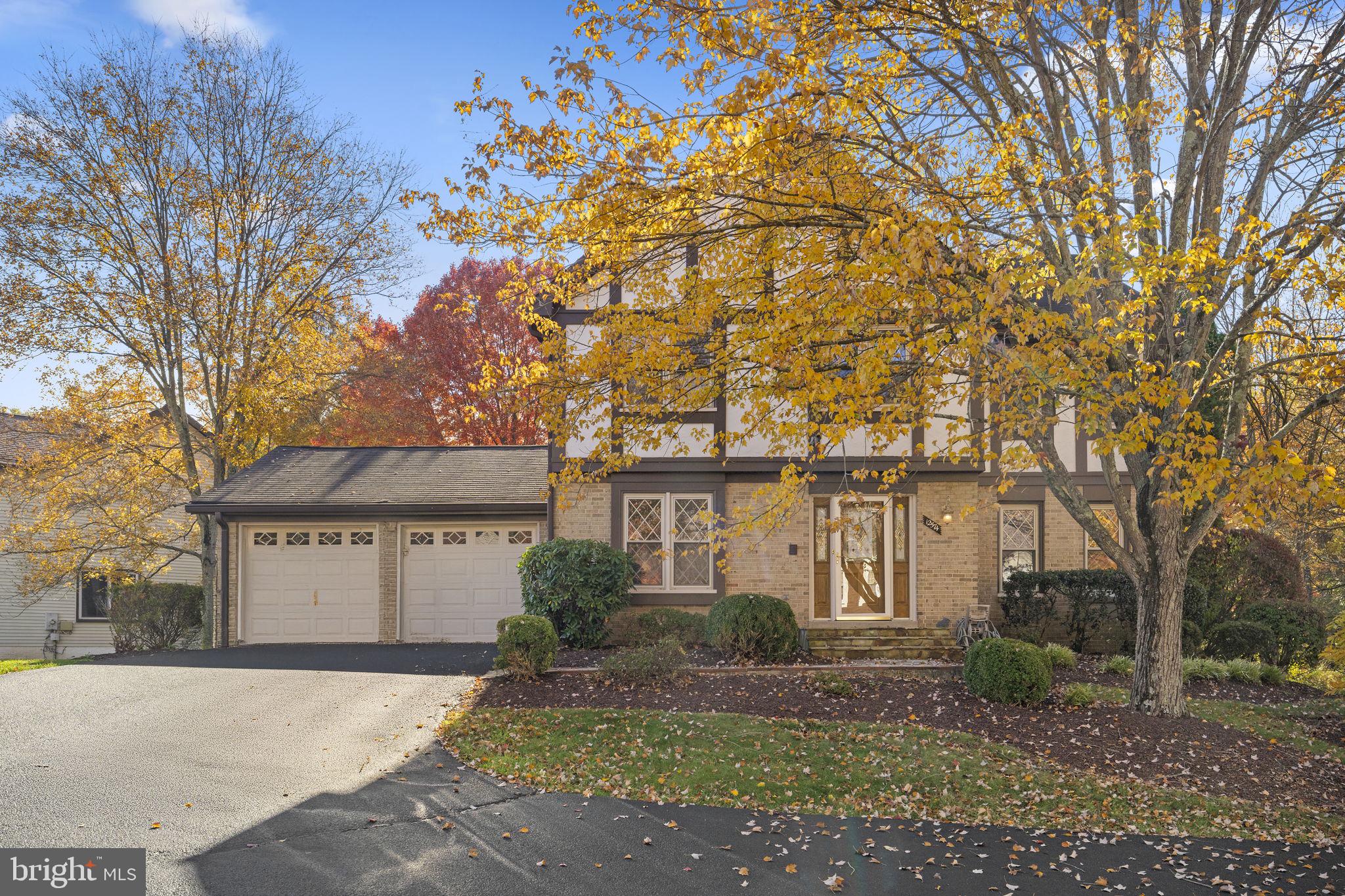 12574 Quincy Adams Court Herndon, VA 20171 - Photo 2 of 67 a front view of a house with garden