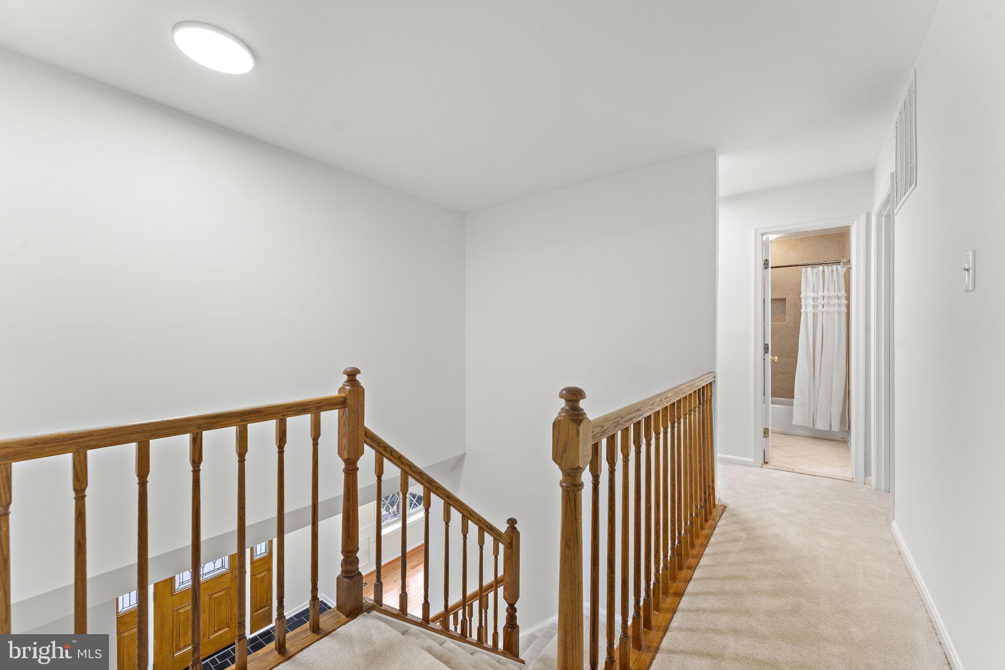 12574 Quincy Adams Court Herndon, VA 20171 - Photo 22 of 67 a view of a hallway with wooden floor and stairs