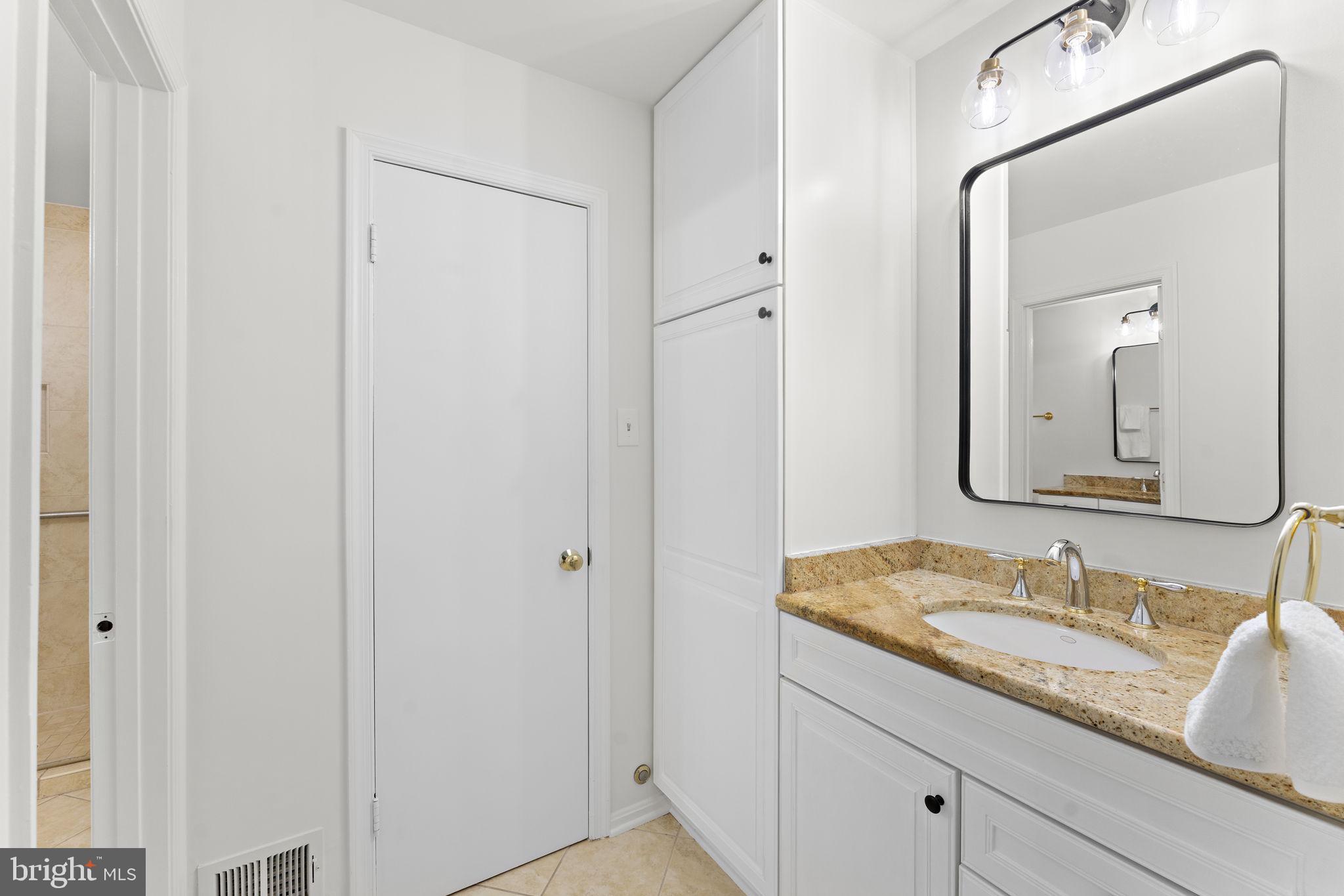 12574 Quincy Adams Court Herndon, VA 20171 - Photo 30 of 67 a bathroom with a granite countertop sink and a mirror