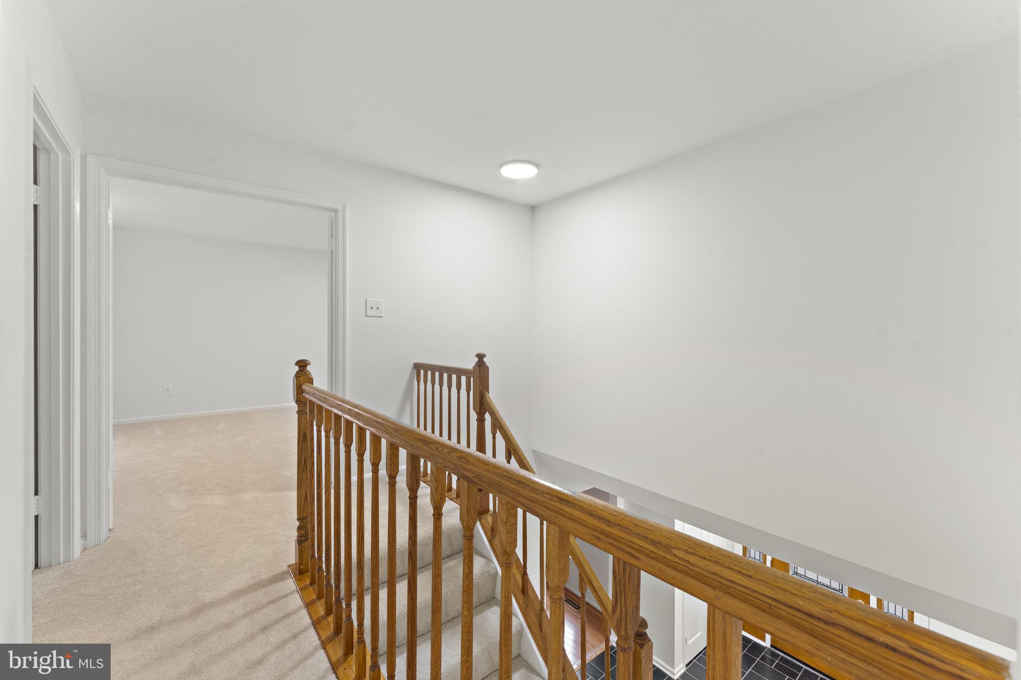 12574 Quincy Adams Court Herndon, VA 20171 - Photo 36 of 67 a view of staircase with railing and white walls