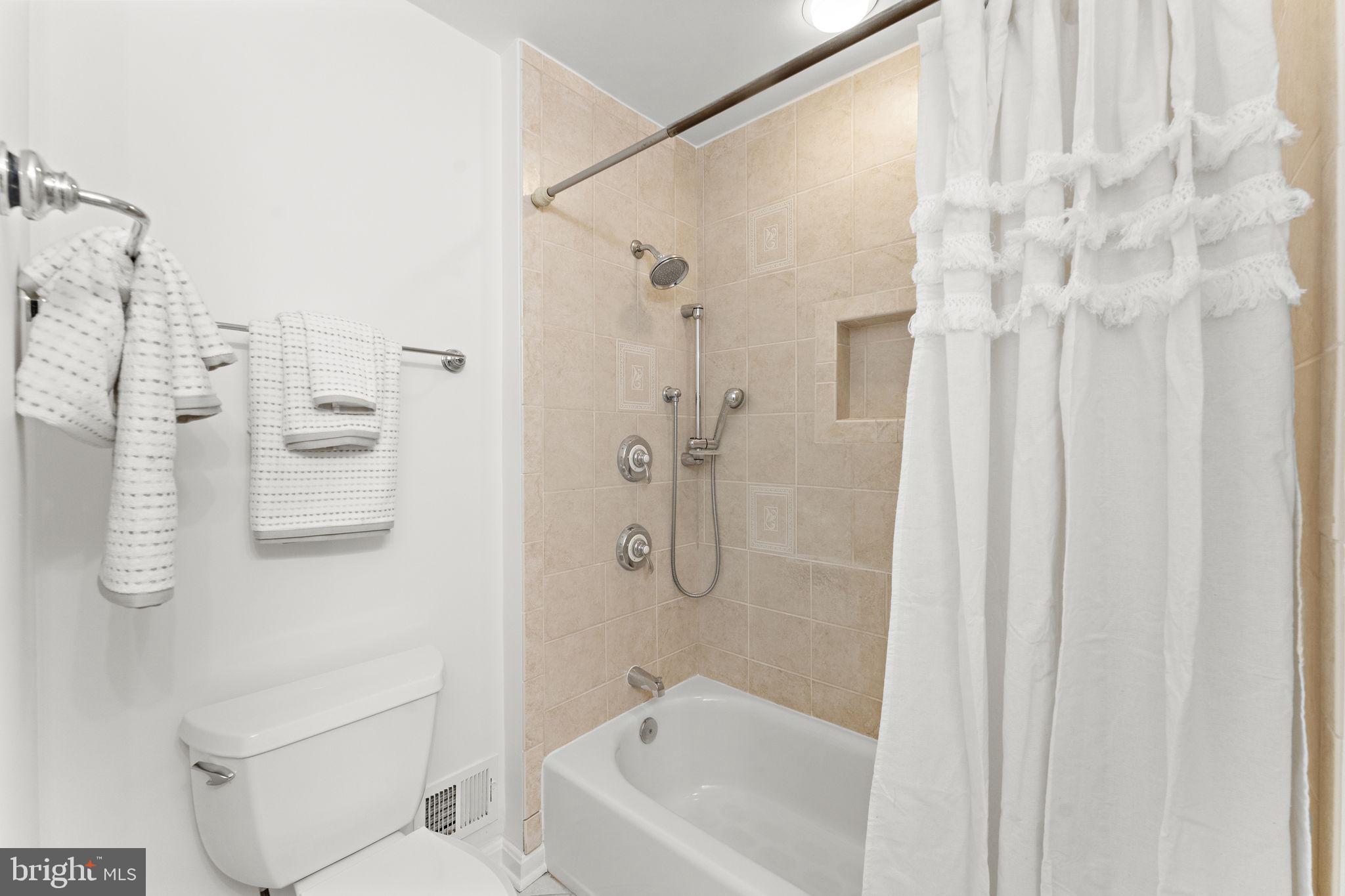 12574 Quincy Adams Court Herndon, VA 20171 - Photo 39 of 67 a bathroom with a shower curtain and a sink
