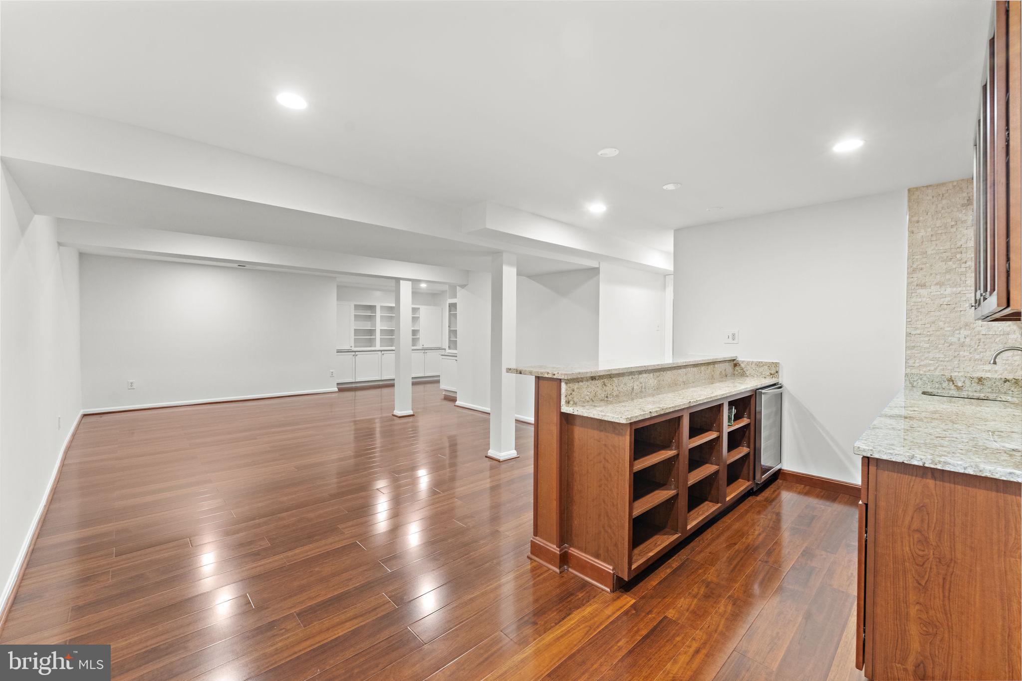 12574 Quincy Adams Court Herndon, VA 20171 - Photo 41 of 67 a room with wooden floors and furniture