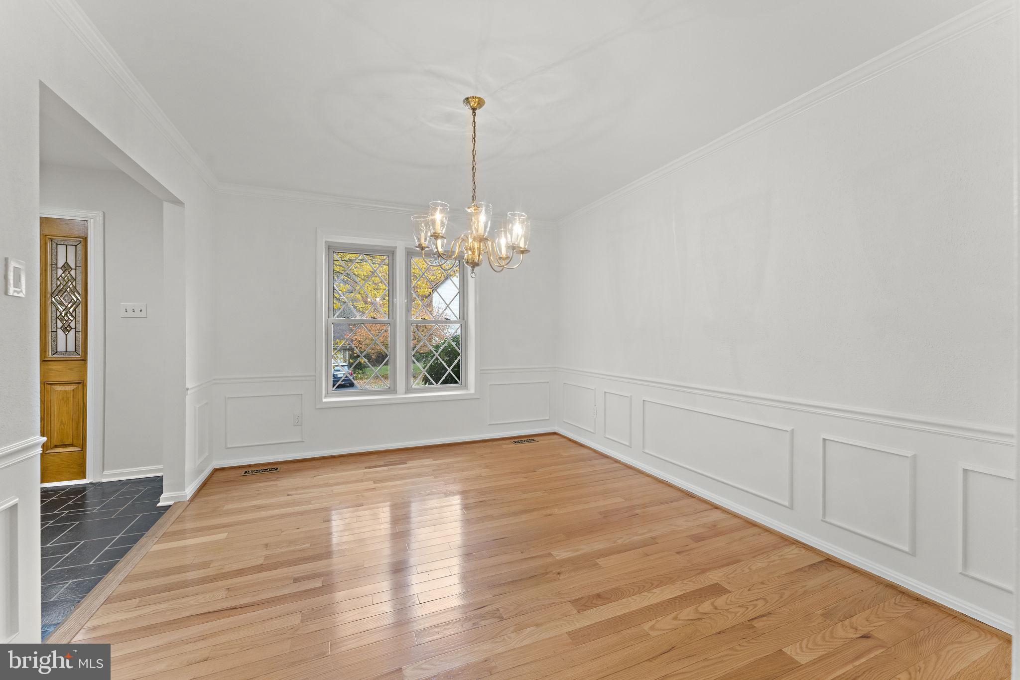 12574 Quincy Adams Court Herndon, VA 20171 - Photo 8 of 67 a view of an empty room with wooden floor and a window