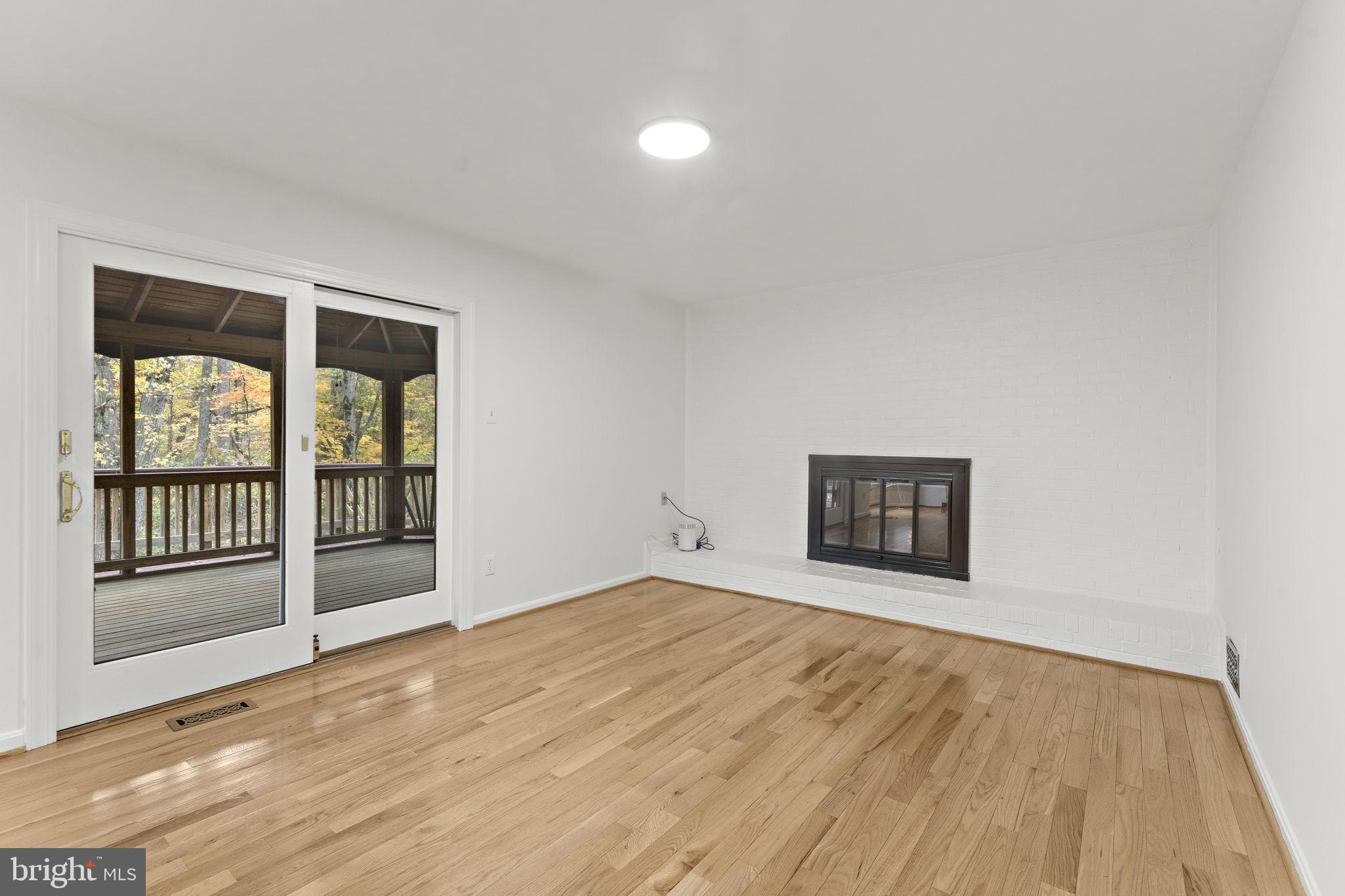 12574 Quincy Adams Court Herndon, VA 20171 - Photo 9 of 67 a view of an empty room with a window and wooden floor