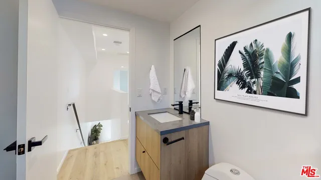 a bathroom with a sink toilet and mirror