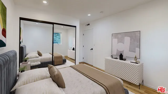a bedroom with furniture and a glass door