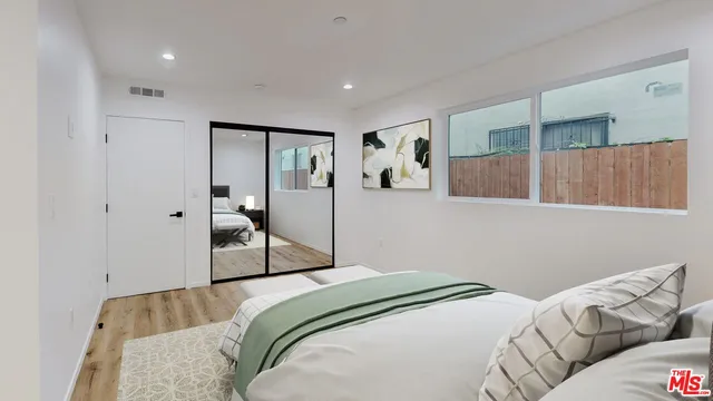 a bedroom with a bed and with the bathroom