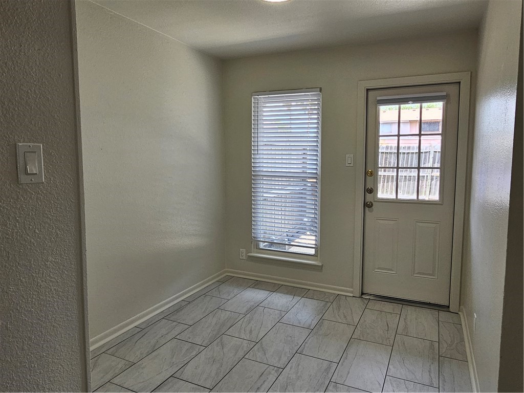 4816 Delwood Street, Unit 4 Corpus Christi, TX 78413 - Photo 9 of 22 an empty room with windows