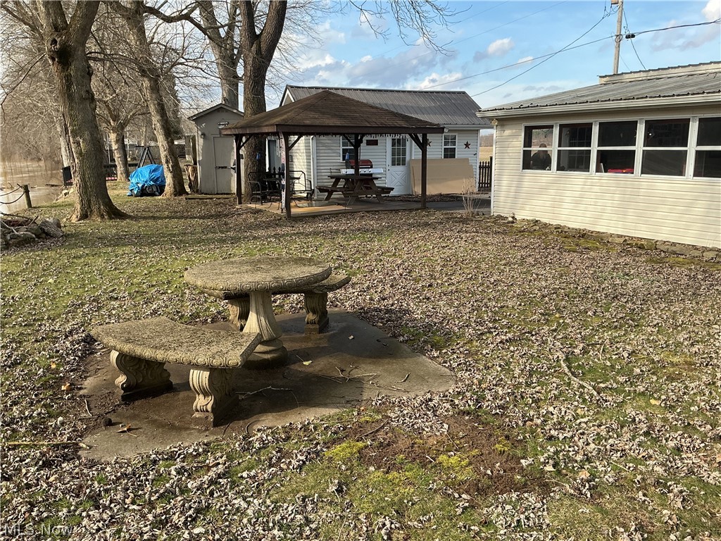9385 North River Road East, Unit 33 Dresden, OH 43821 - Photo 5 of 19 Back of house featuring a patio area, a gazebo, and a metal roof