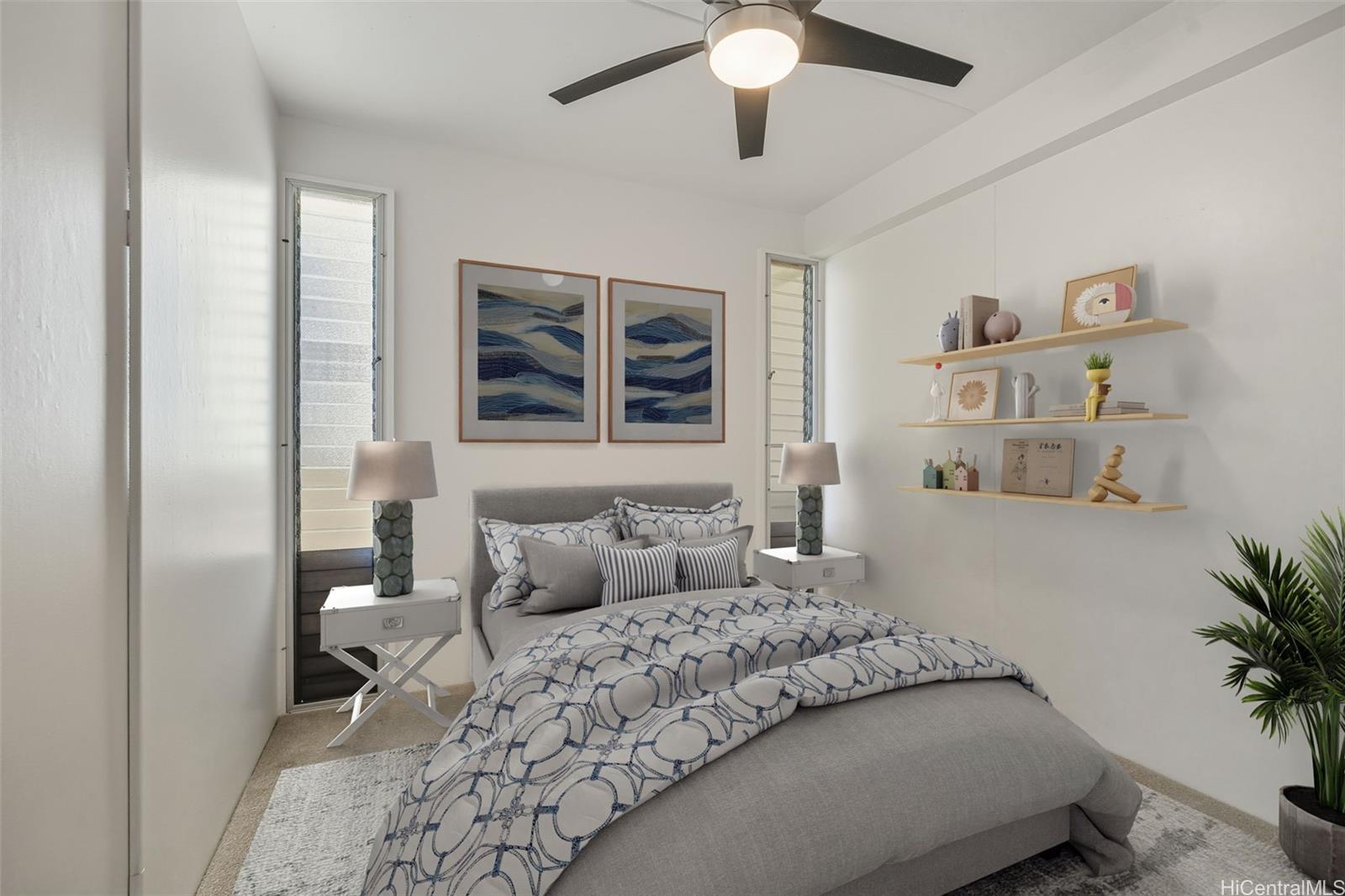 910 Ahana Street, Unit 308 Honolulu, HI 96814 - Photo 11 of 20 a bedroom with a large bed and a chandelier