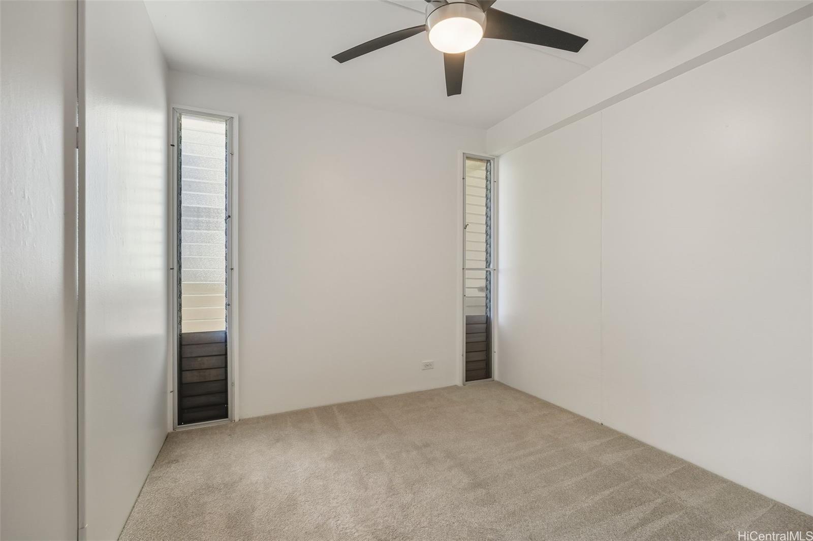910 Ahana Street, Unit 308 Honolulu, HI 96814 - Photo 13 of 20 an empty room with closet and a chandelier fan