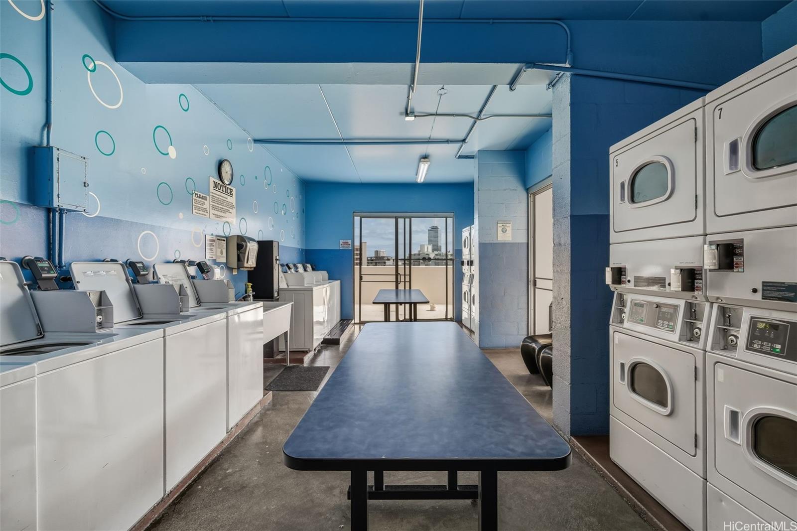 910 Ahana Street, Unit 308 Honolulu, HI 96814 - Photo 17 of 20 a open kitchen with stainless steel appliances granite countertop a stove a refrigerator a sink dishwasher and white cabinets with wooden floor