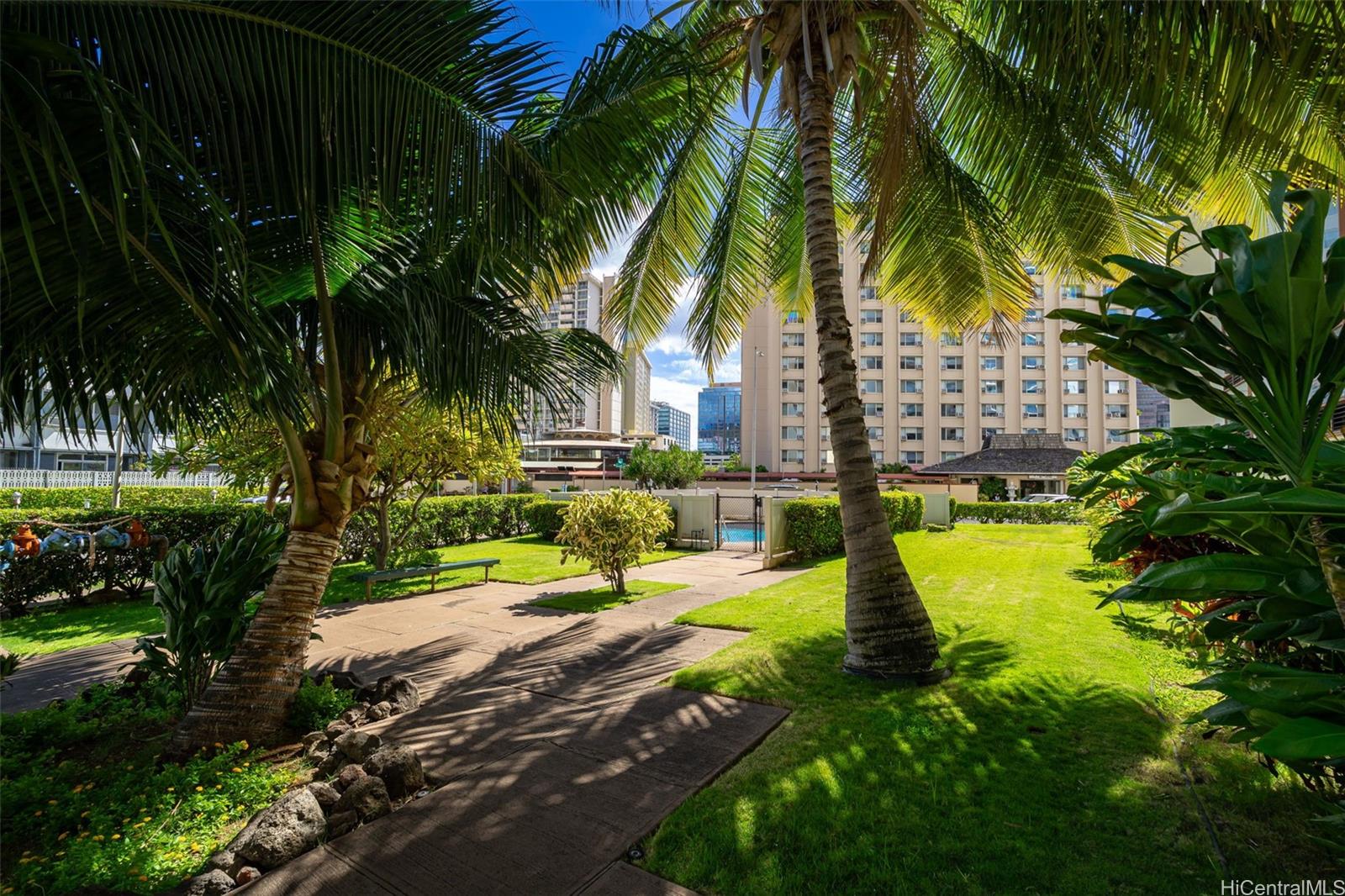 910 Ahana Street, Unit 308 Honolulu, HI 96814 - Photo 19 of 20 a view of a backyard with swimming pool