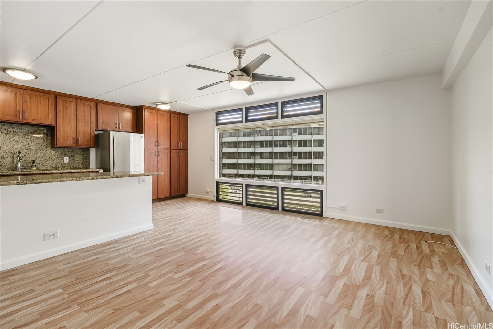 910 Ahana Street, Unit 308 Honolulu, HI 96814 - Photo 3 of 20 a view of kitchen with wooden floor electronic appliances and window
