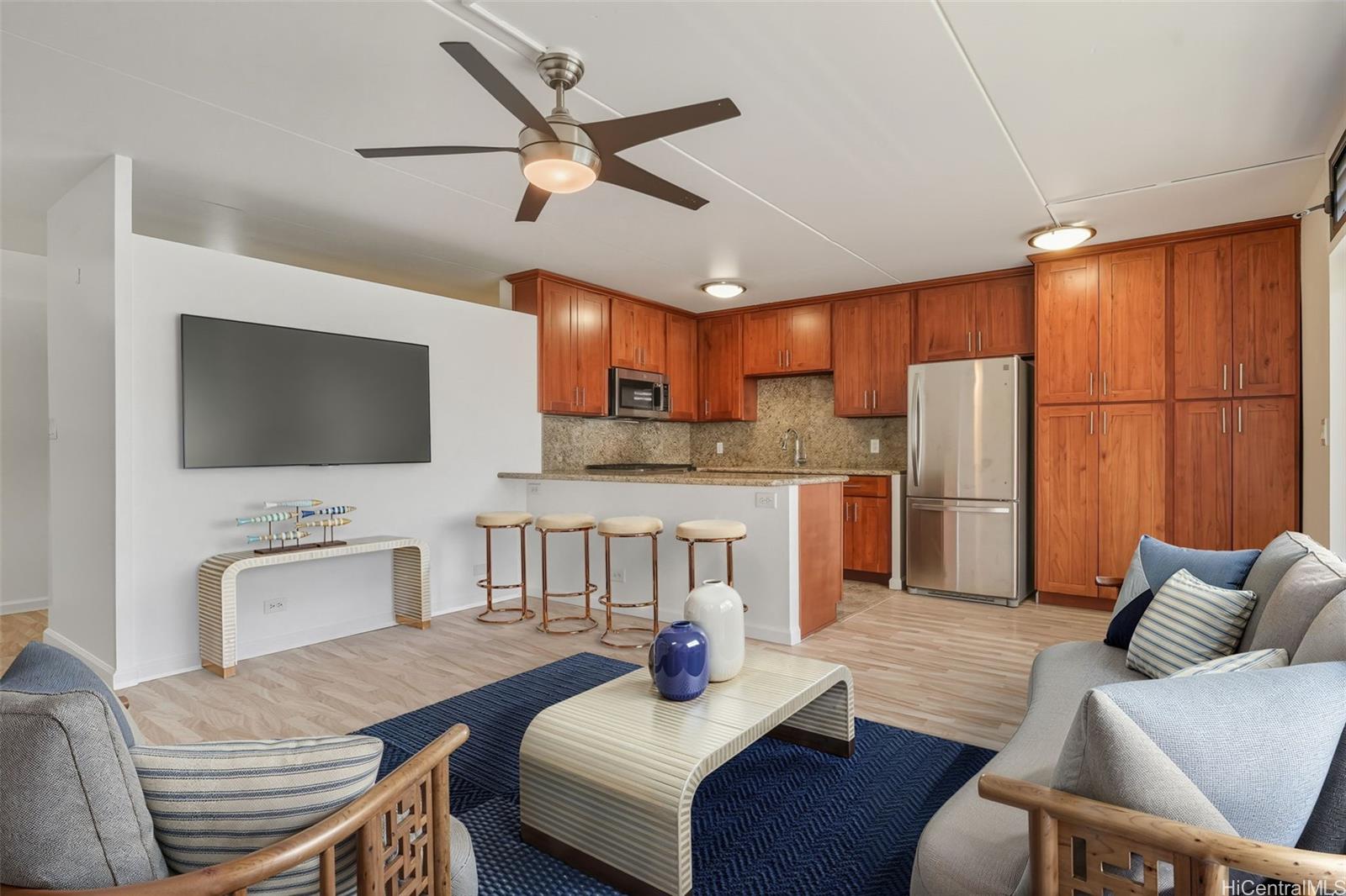 910 Ahana Street, Unit 308 Honolulu, HI 96814 - Photo 4 of 20 a living room with furniture and a flat screen tv