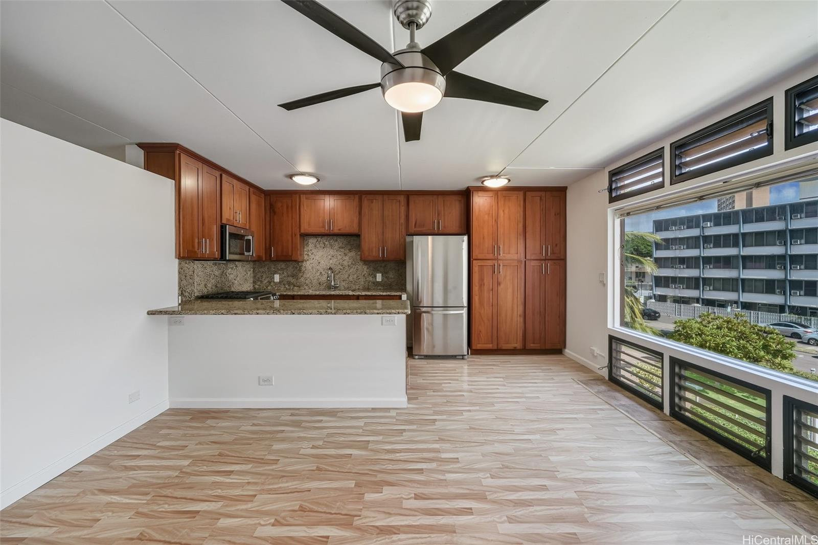 910 Ahana Street, Unit 308 Honolulu, HI 96814 - Photo 5 of 20 a view of kitchen with refrigerator and ceiling fan