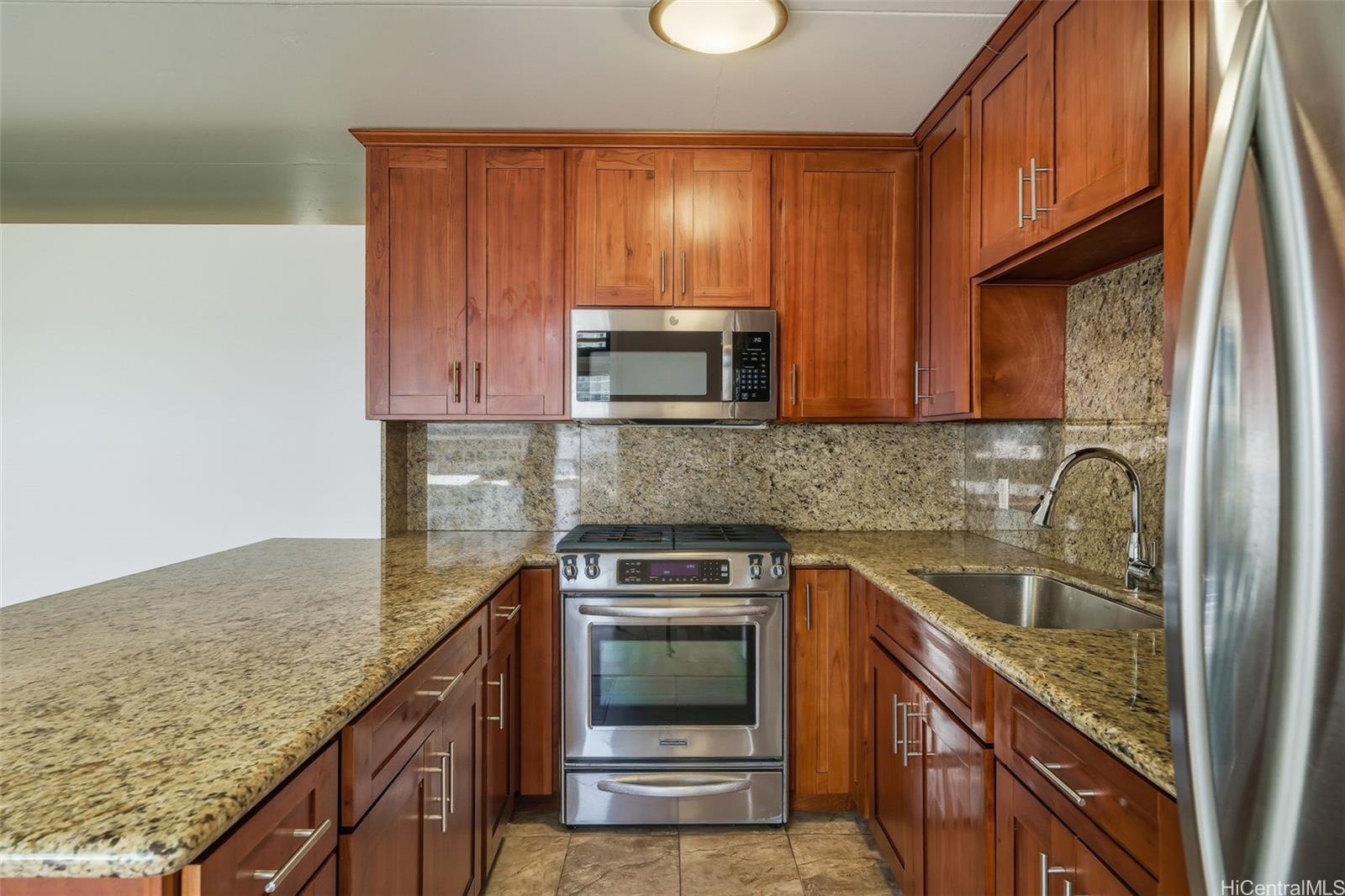 910 Ahana Street, Unit 308 Honolulu, HI 96814 - Photo 8 of 20 a kitchen with granite countertop cabinets stainless steel appliances and a sink