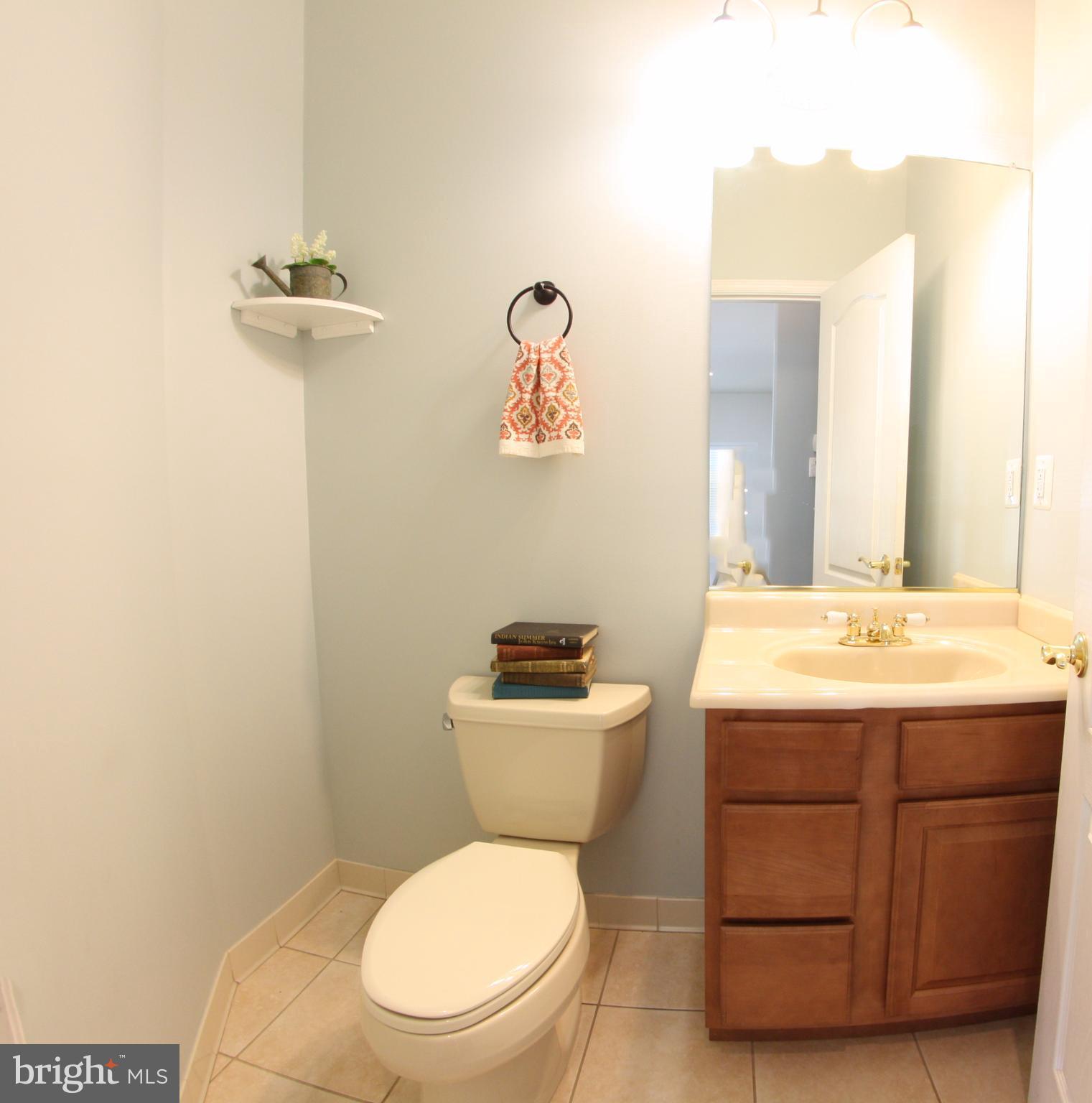 824 Andover Road Linthicum, MD 21090 - Photo 18 of 29 a bathroom with a granite countertop toilet sink and mirror