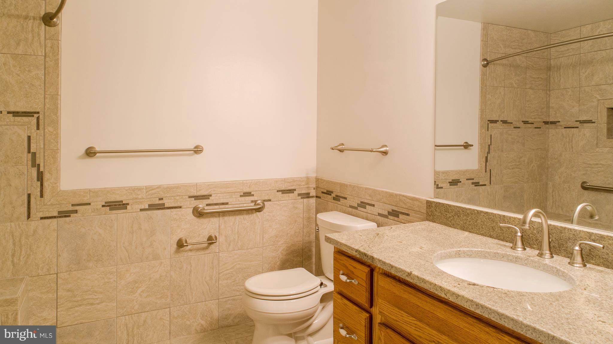 824 Andover Road Linthicum, MD 21090 - Photo 25 of 29 a bathroom with a granite countertop sink toilet and shower