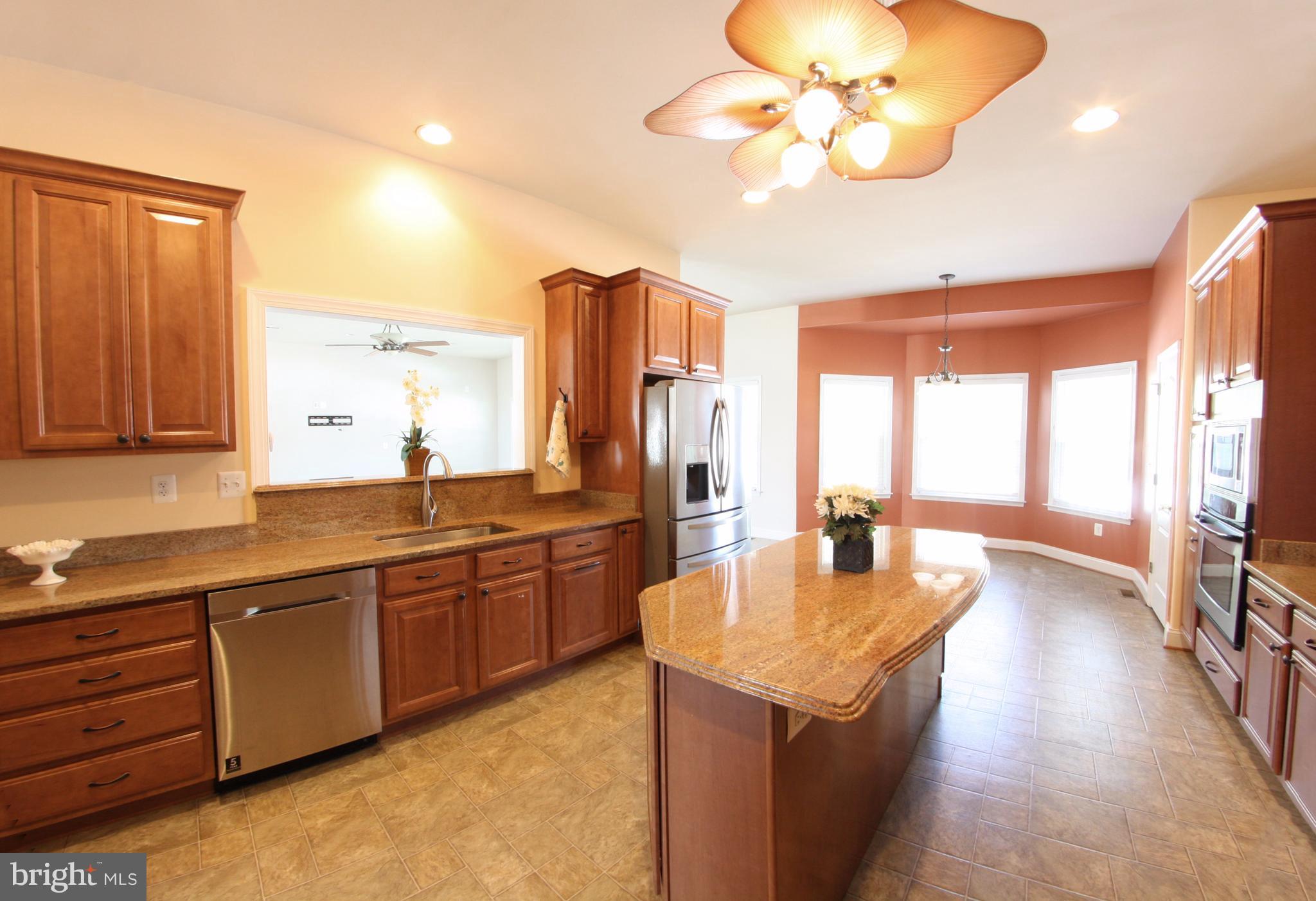 824 Andover Road Linthicum, MD 21090 - Photo 4 of 29 a large kitchen with kitchen island granite countertop a sink and dishwasher large window with wooden floor