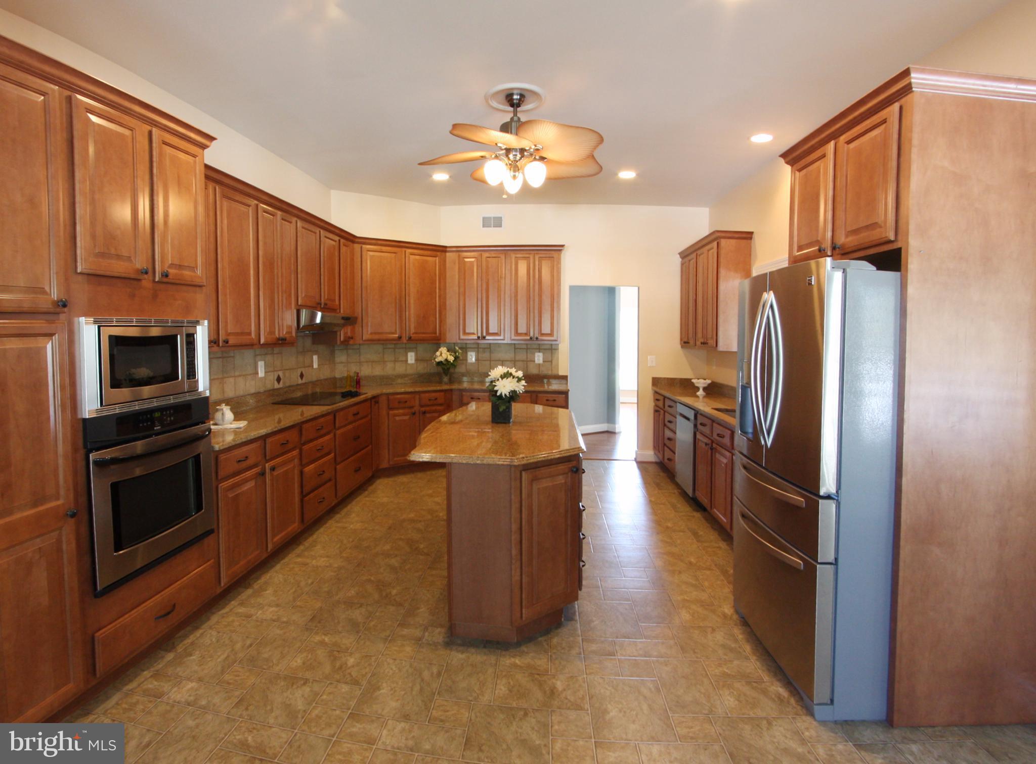 824 Andover Road Linthicum, MD 21090 - Photo 5 of 29 a kitchen with stainless steel appliances granite countertop a refrigerator a sink dishwasher stove and oven