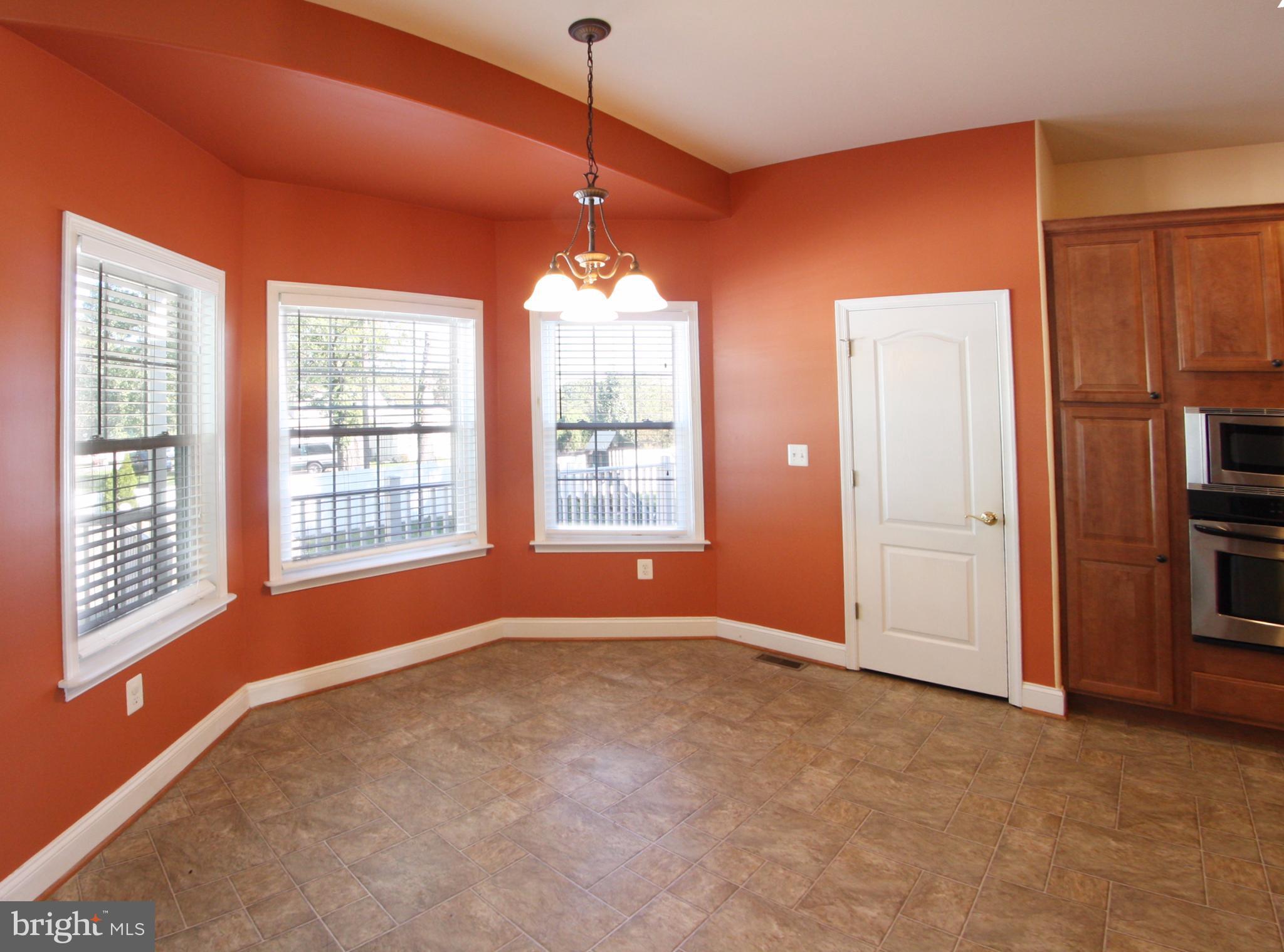824 Andover Road Linthicum, MD 21090 - Photo 6 of 29 a view of an empty room with a window and chandelier fan