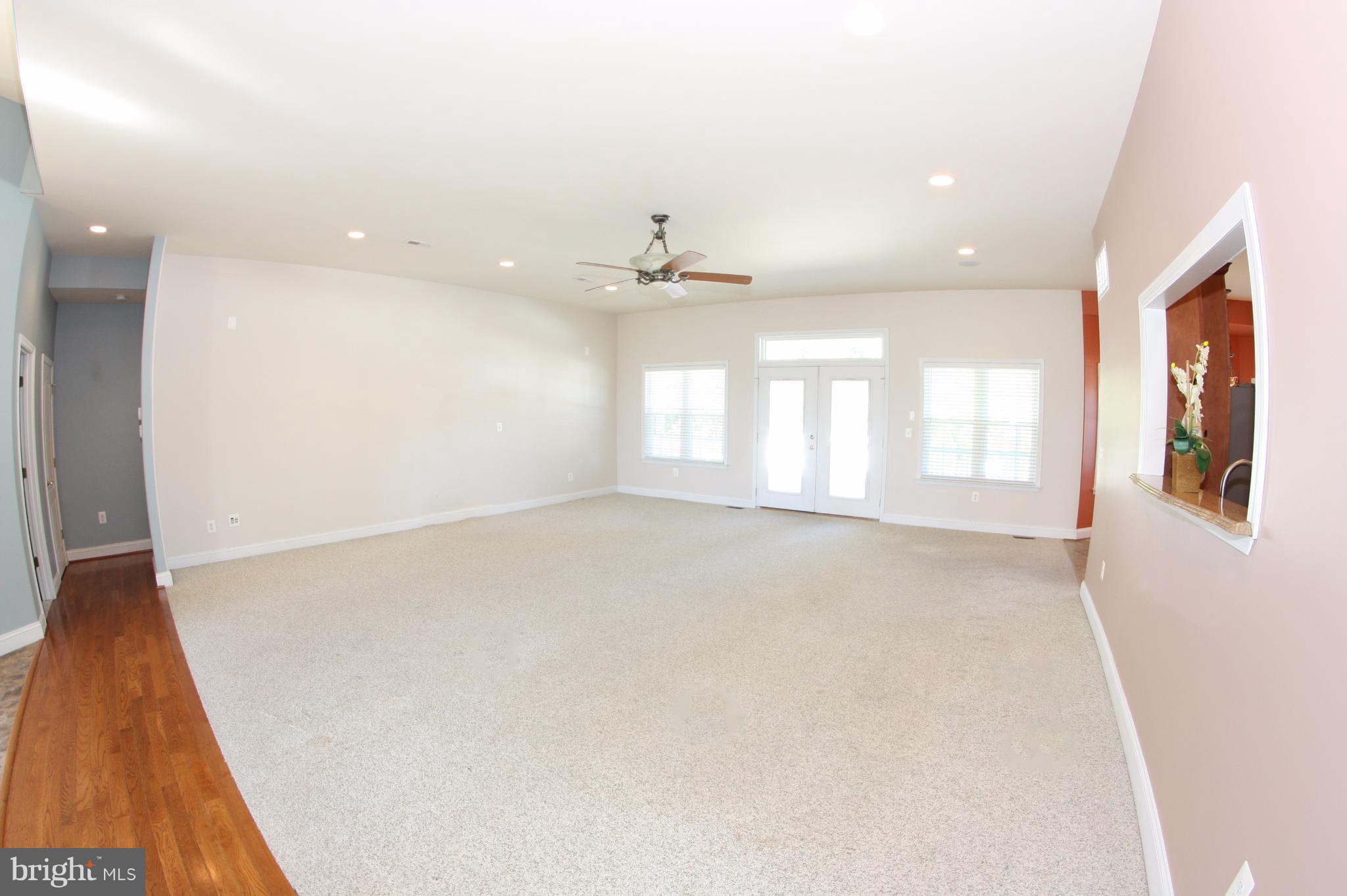 824 Andover Road Linthicum, MD 21090 - Photo 9 of 29 an empty room with windows and ceiling fan