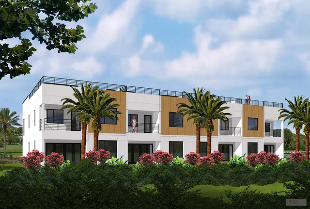 a front view of residential houses with yard