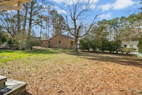 a view of a yard with yellow house
