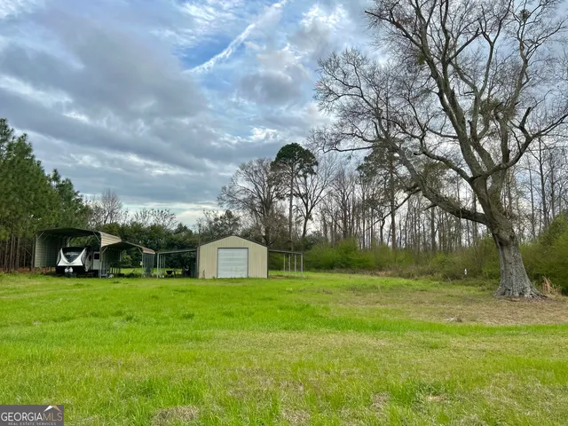 a view of yard with swimming pool and green space