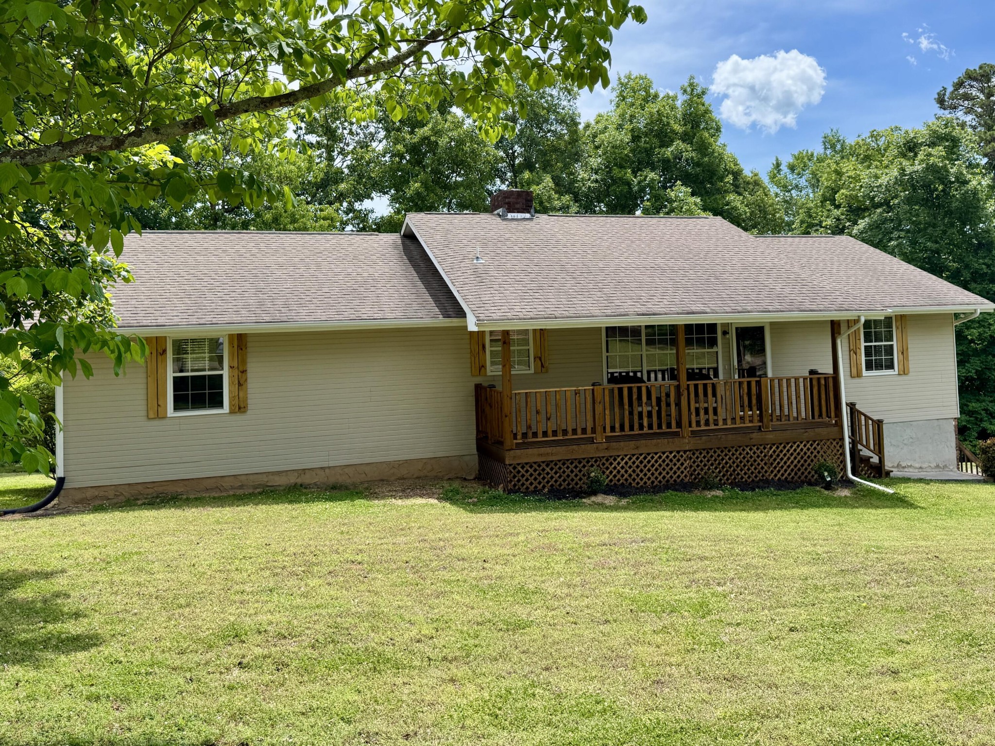 a view of a house with a yard and sitting area