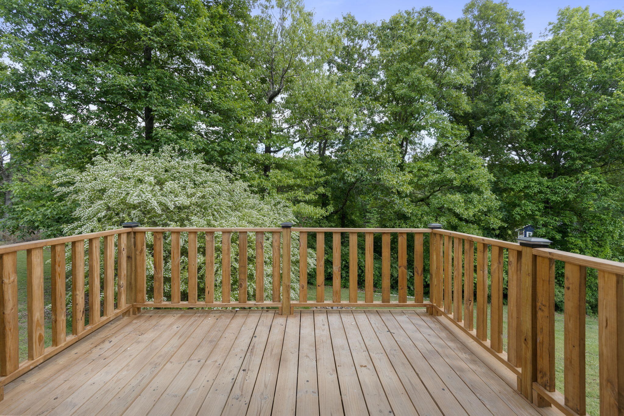9814 Lakeside Road Harrison, TN 37341 - Photo 13 of 35 a balcony with wooden floor and trees in the background