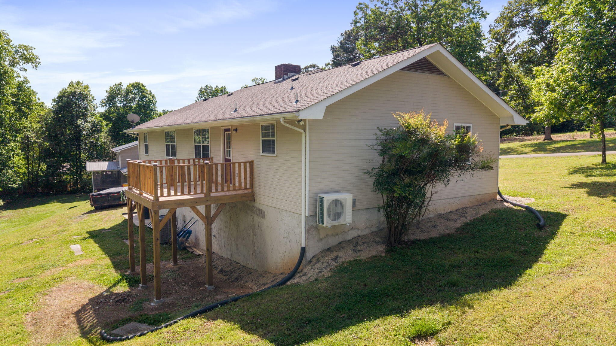 9814 Lakeside Road Harrison, TN 37341 - Photo 32 of 35 a front view of a house with garden yard and deck