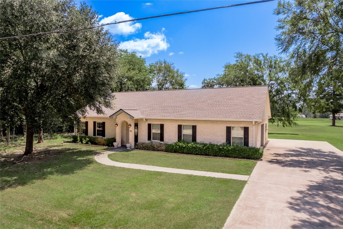 22 Greenway Drive Trinity, TX 75862 - Photo 4 of 29 a front view of a house with a garden