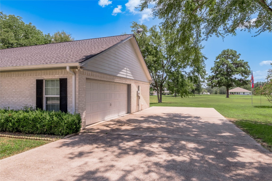 22 Greenway Drive Trinity, TX 75862 - Photo 5 of 29 a view of a house with yard and a garage