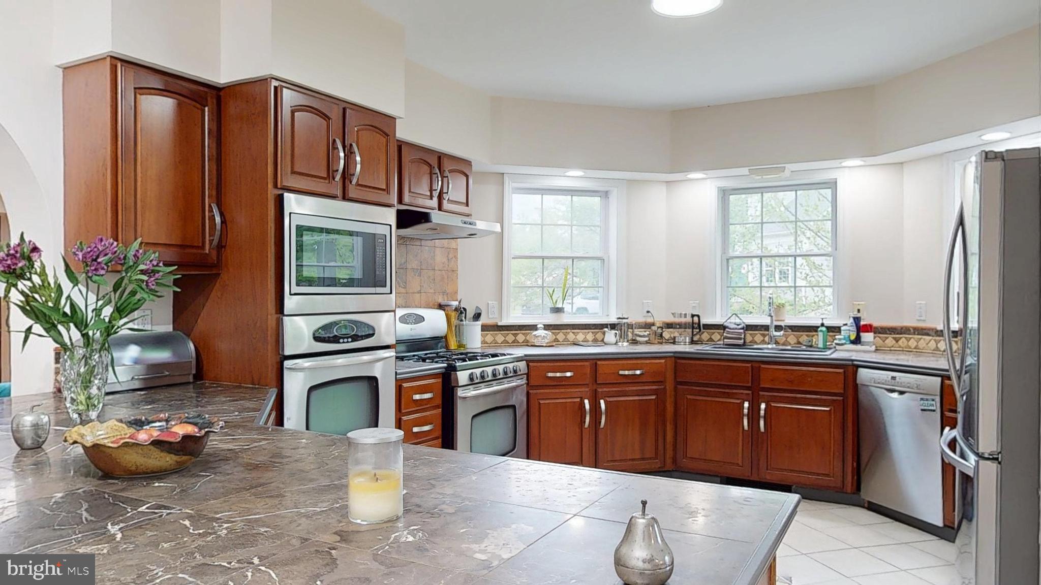 226 Ark Road Mount Laurel, NJ 08054 - Photo 30 of 60 a kitchen with stainless steel appliances a sink stove and wooden cabinets