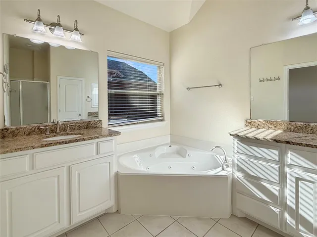 a spacious bathroom with a shower and a sink
