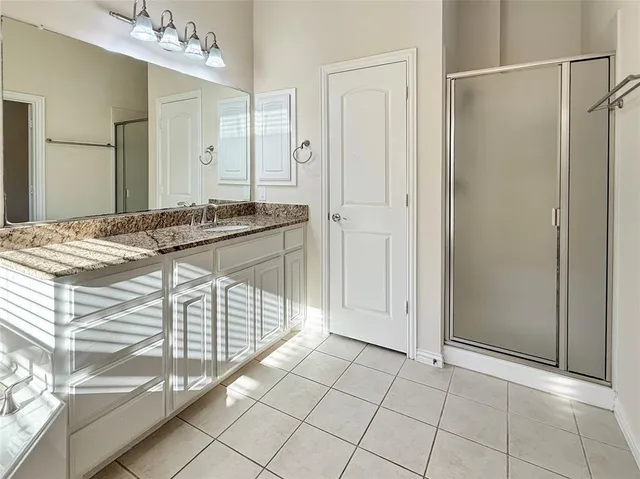 a view of empty room with wooden floor and cabinet