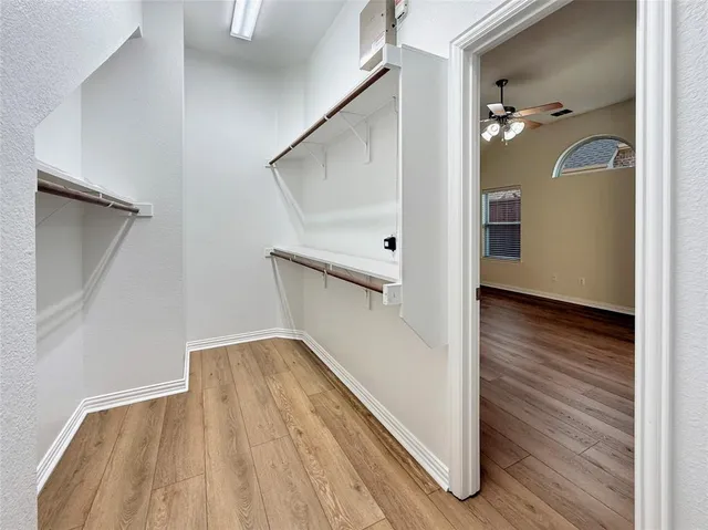a view of a room with wooden floor and a window