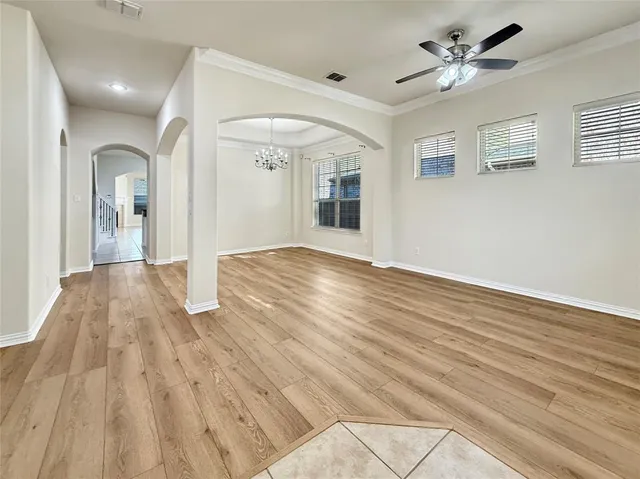 a view of empty room with wooden floor