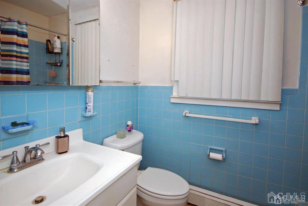 28 Magnolia Road Iselin, NJ 08830 - Photo 15 of 37 a bathroom with a sink a toilet and mirror