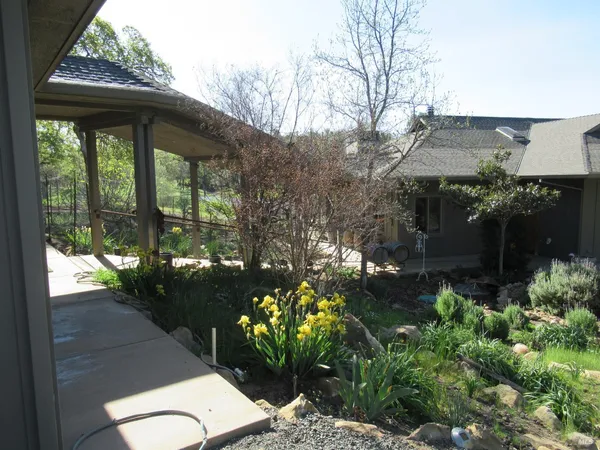 a backyard of a house with outdoor seating