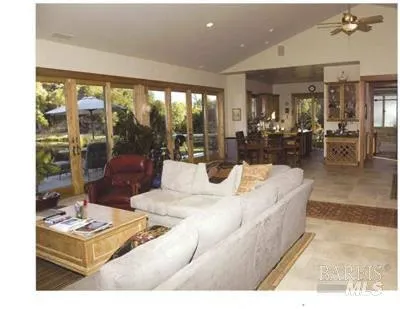 a living room with a large window and a table