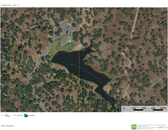 a view of a lake with a yard and trees