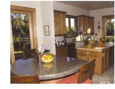 a kitchen with a sink a stove and chairs