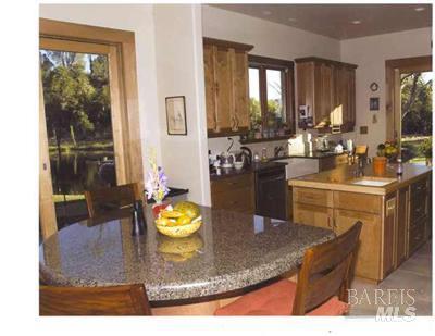 18300 Morgan Valley Road Lower Lake, CA 95457 - Photo 5 of 55 a kitchen with a sink a stove and chairs