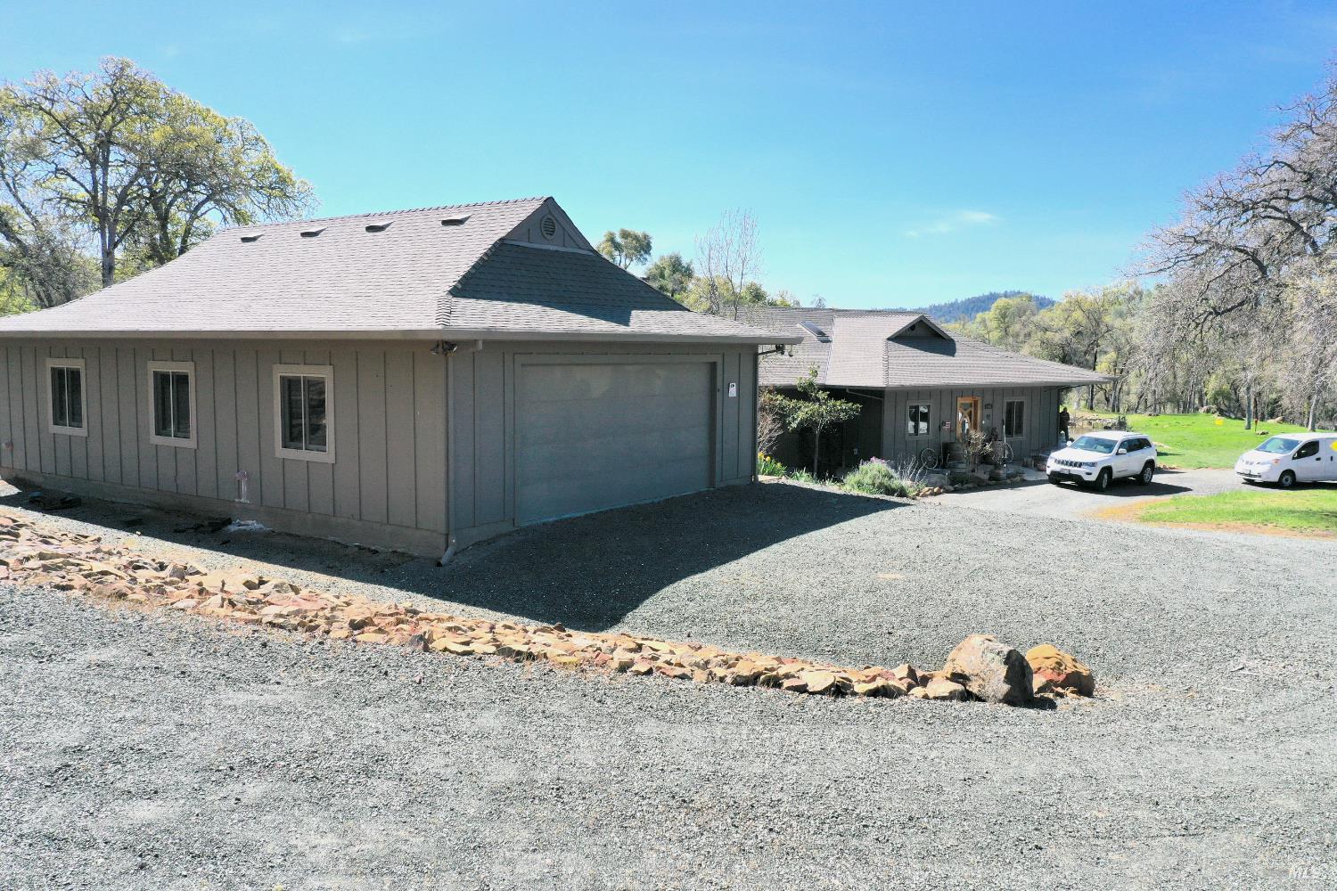18300 Morgan Valley Road Lower Lake, CA 95457 - Photo 55 of 55 a front view of a house with a yard and garage