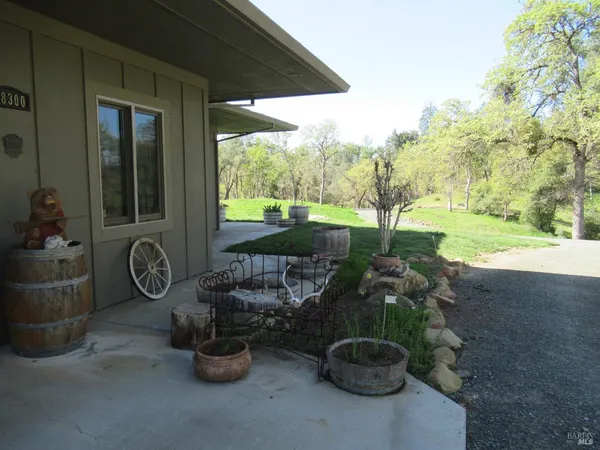 a backyard of a house with barbeque oven table and chairs