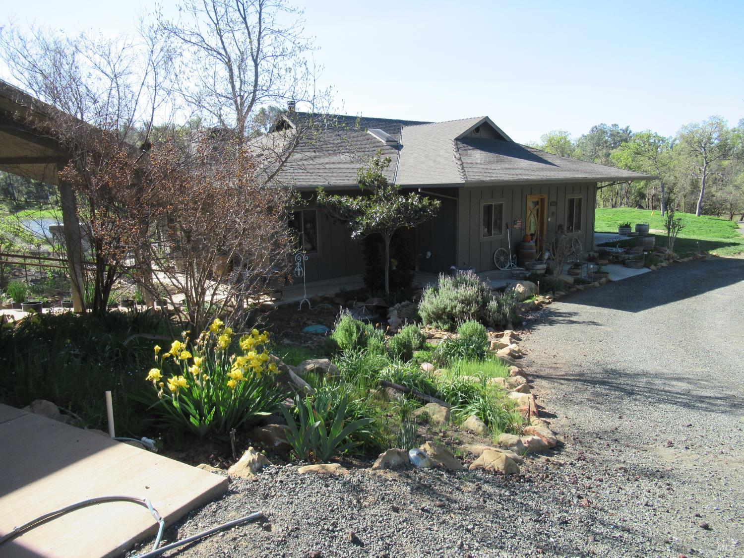 18300 Morgan Valley Road Lower Lake, CA 95457 - Photo 8 of 55 a view of a house with a yard and garden